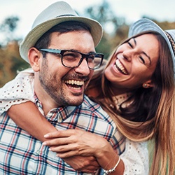 Closeup of couple smiling in field outside