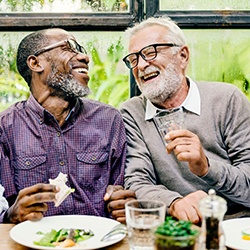 Patient in Abingdon laughing with friends with dentures