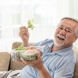 Patient in Abingdon eating with dentures