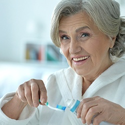 Patient in Abingdon about to brush with dentures