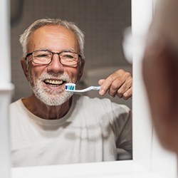 Day-to-day benefits of implant dentures include easier care and maintenance than traditional dentures