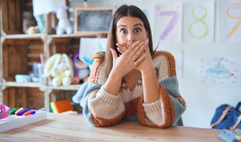 Woman with knocked out tooth covering her mouth