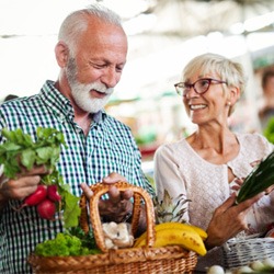A happy senior couple buying fresh food
