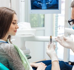 A dentist telling his patient about the long-term benefits of dental implants