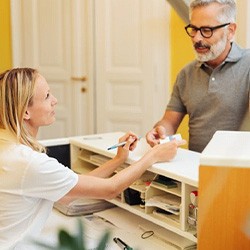 Man speaking to a receptionist