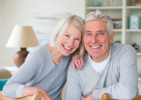 Older man and woman sharing smile after restorative dentistry