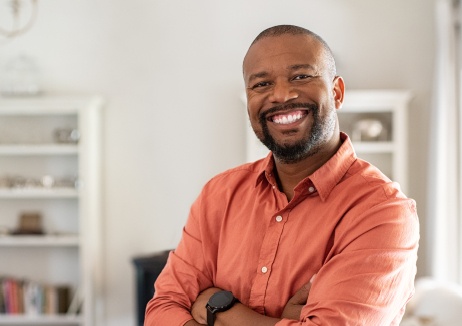 Man smiling after replacing missing teeth