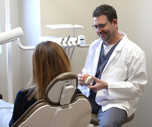 Dentist discussing dental services with dental patient
