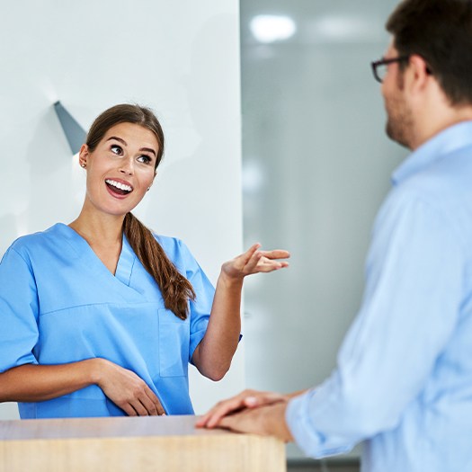 Dental team member talking to patient about dental insurance coverage