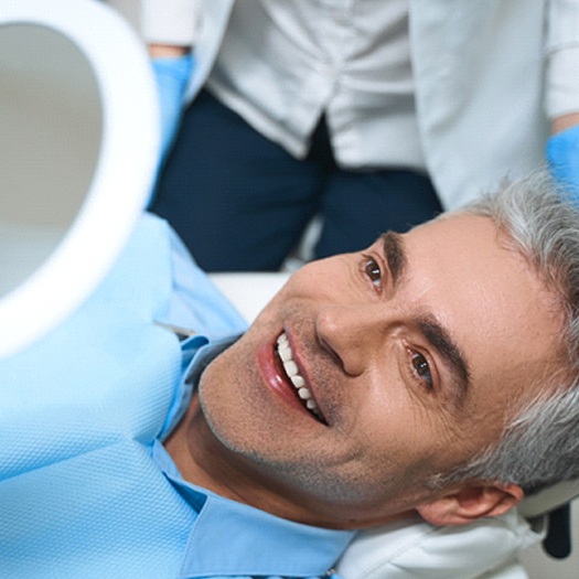 Man admiring his smile after KOR® teeth whitening in Abingdon