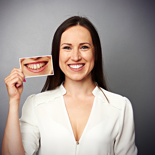 woman holding picture of before KOR® teeth whitening in Abingdon