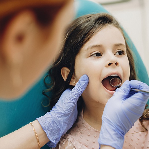 Young girl receiving dental checkup and teeth cleaning
