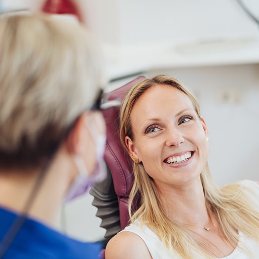 Woman with healthy smile after periodontal disease treatment