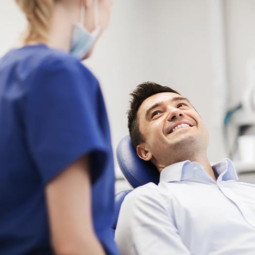 Man smiling during dental checkup and teeth cleaning visit