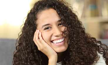 Young woman with healthy smile after wisdom tooth extraction