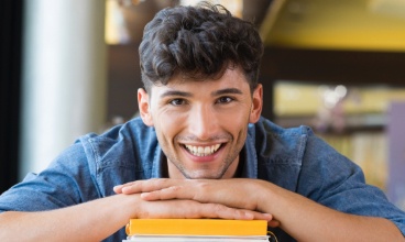 Young man with aligned smile after Invisalign clear braces