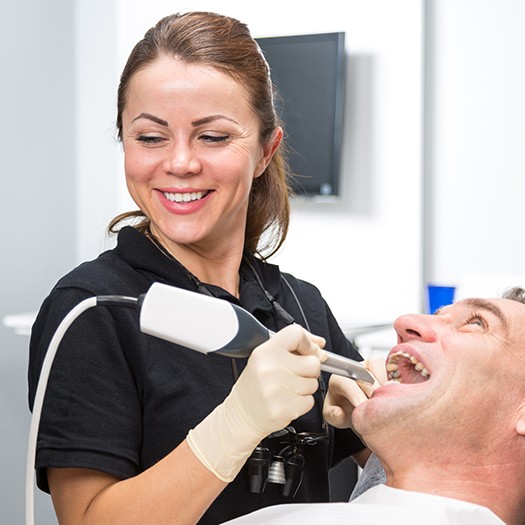 Dental team member using early cavity detection system