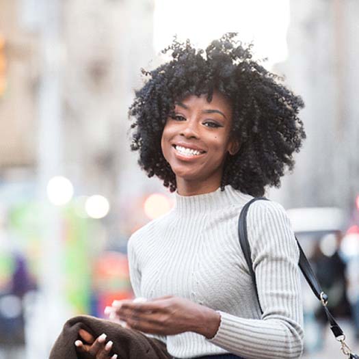 Woman with veneers in Abingdon, VA smiling on street